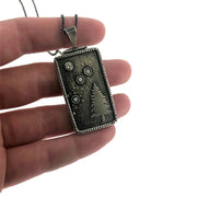 Close up image of Starry Night Pendant with CZ Rectangles with hinge bail with hand in background to give scale.