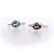 Front view of Ada Ring both Amethyst and Blue Topaz next to one another.