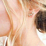 Full view of Peridot Cambrye Earrings being worn to show their size compared to one's ear.