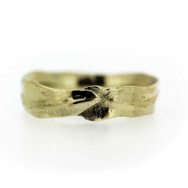 Full view of Men's Frond Band. This band is reminiscent of foliage and is made of gold.