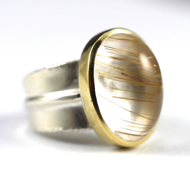 Side view of Golden Rutilated Quartz Ridge Ring. The silver band resembles that of a leaf's spine.