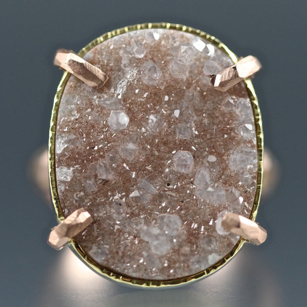 Detail shot of peach druzy gemstone on ring. Here you can see its raw nature and all of its crystals.
