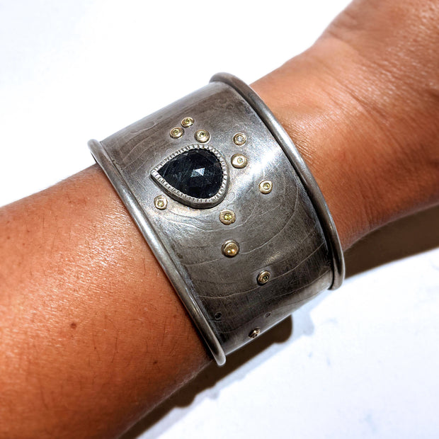 Full view of Sapphire Cuff Bracelet on woman's wrist to help give an idea of its scale.