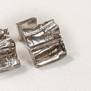 Angled view of one Summit Cufflink.