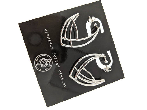 Full image of Medium Cat's Eye Hoop Earrings on display card to give idea of scale of piece. These earrings were inspired by a cats eye and are made of intertwining lines of wire to create the shape of a cats eye.