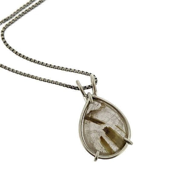 Close up image of pendant of Rutilated Quartz Pear Pendant. This pendant has a set rutilated quartz in the shape of a teardrop set in silver.