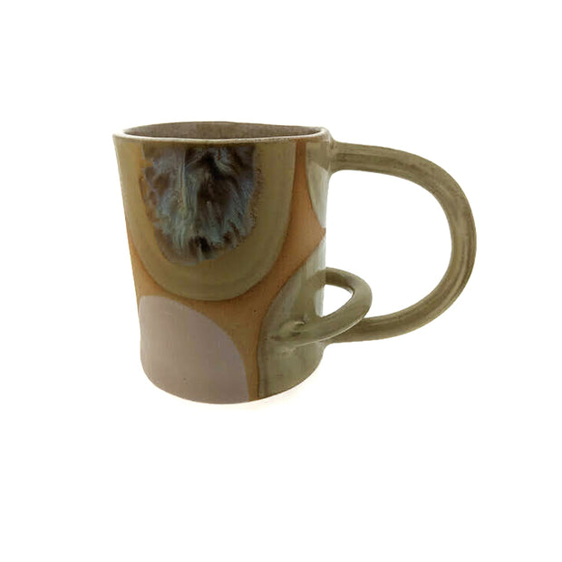 Full image of horizontal arch mug on white background. This mug is made with a variety of tans and creams. The handle of the mug is an elongated horizontal arch and has another arch within the handle near the bottom.