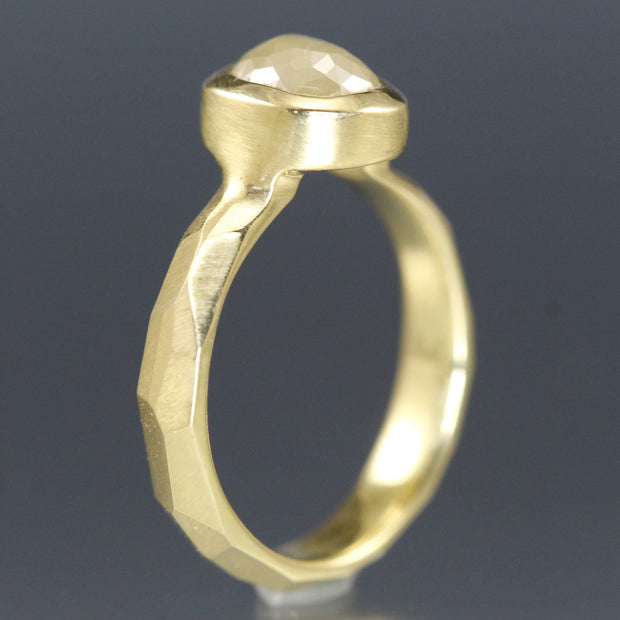 Side view of a yellow gold ring with a creamy yellow rose cut diamond.