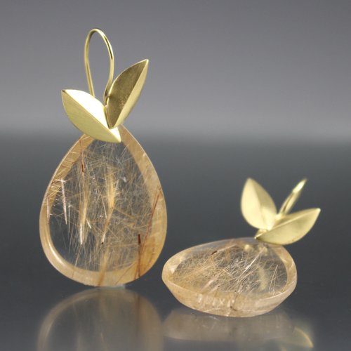 Full image of Gold Rutile Quartz Earrings, with one laying down and the other propped up.