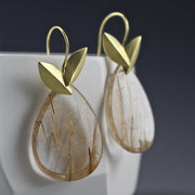 Full image of Gold Rutile Quartz Earrings. The rutile quartz earrings are in the shape of a pear and are the top are two leaves in the shape of a "v".