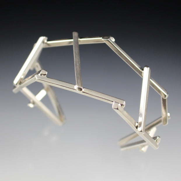 Top view of a dramatic, architectural sterling silver cuff bracelet.