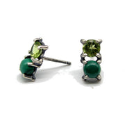 Full view of green Gemstone Stud Earrings. These dainty little studs feature 2 prong-set gemstones, peridot and malachite, that sit next to each other in a beautiful complementary pair. The post is placed right in the center so you can arrange the stud on your earlobe as you wish.  A perfect second hole or every day stud earring. 