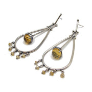 Full view of Citrine Chandelier Earrings. These dangle earrings have a teardrop outline with tiny stones of citrine hanging off its bottom (five of them) and inside the teardrop is a hinge with a set citrine at its base.
