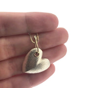 Detail shot of pendant on Hooked Heart - Large with hand in background to help give an idea of its scale.