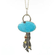Frontal image of pendant on River Lichen Kingman Turquoise and Ruby Pendant on white background.