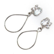Sterling silver dangle earrings with three white topaz gemstone in various shapes and a tear drop shaped dangle.