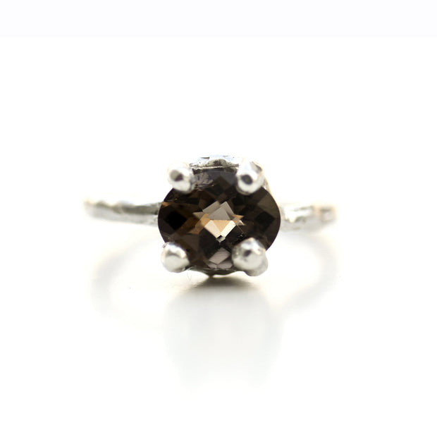 Top view of Ada Ring. This ring is made of silver and has a smoky quartz set at its top with four silver prongs.