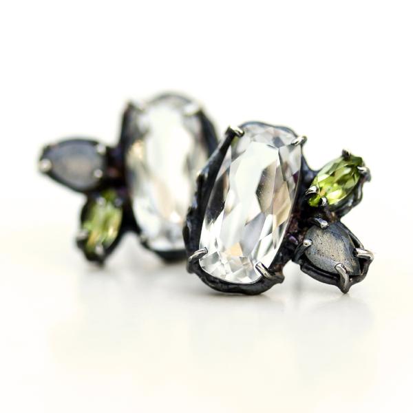 Stud earrings with white topaz, peridot and labradorite clustered together in an organic blackened sterling silver setting.
