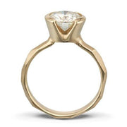 Side view of a Modern 14k yellow gold Engagement Ring with a Partial Bezel, allowing light to shine through the Moissanite Stone.