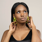 Full view of Lace Dangle Earrings - Chartreuse being modeled to help give an idea of their scale. These earrings have two layers, the top a lacey circle and the bottom a teardrop dangle