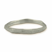 Full view of silver skinny facet ring.