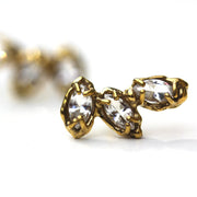detail photo of Stud earrings made of three marquise shaped white topaz stones set with organic prongs