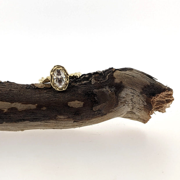 Full view of Annette Mooissanite Ring laying on stick.