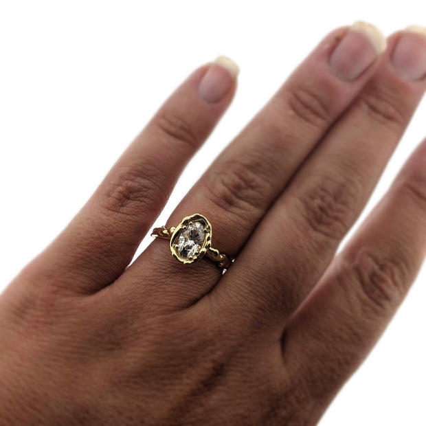 Full view of Annette Moissanite Ring on woman's hand to help give an idea of its scale.