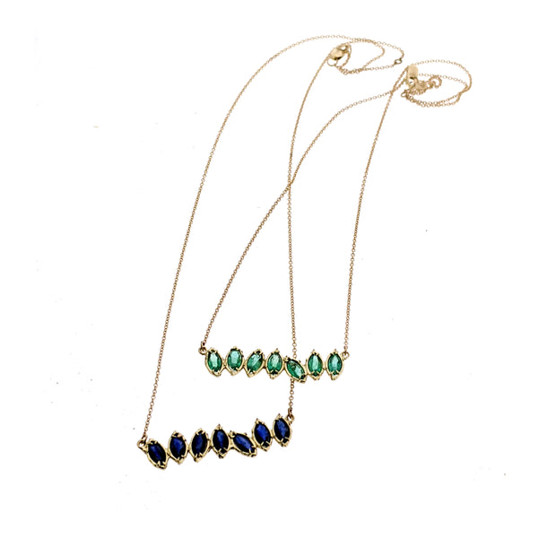Full view of Sapphire and Peridot Cherin Necklaces on white background.