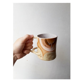 Full image of Horizontal Arch Mug being held to give idea of scale.
