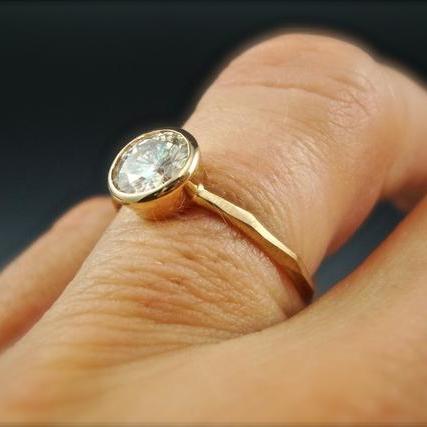 Full view of yellow gold Thin faceted Engagement Ring on woman's finger to help give idea of scale of piece.