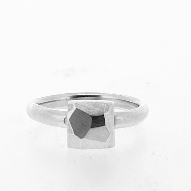 Full view of Faceted Small Square Ring. the pendant is in the shape of a square with a faceted texture on a silver band.