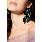 Full view of Black Drop Earrings being worn to help give an idea of their scale. These dangle earrings are in the shape of an upsidedown "U" with two pear shaped pendant dangling from each side.