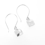 Full view of square faceted dangle earrings on white background.