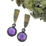 Full view of Fused Wedge Checkerboard Amethyst Drop Earring with moss in background.
