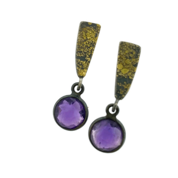 Full view of Fused Wedge Checkerboard Amethyst Drop Earring. These earrings feature a triangular shaped oxidized silver with gold accents and a circle amethyst that dangles from them.
