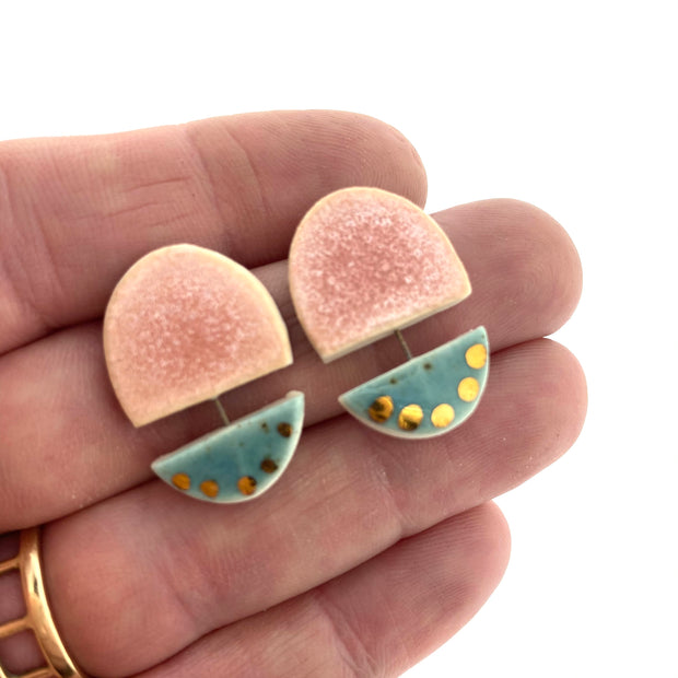 Full view of Pink and Teal with Gold Dots in-between two fingers to help give an idea of its size.