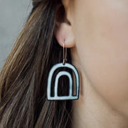 Full view of Enamel Bow Dangle Earrings on woman's ear to help give size of piece.