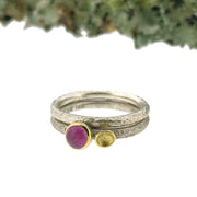 Full view of both Luxe Lichen Stacking Ring Set - Pink Sapphire stacked on top of one another with moss in the background.