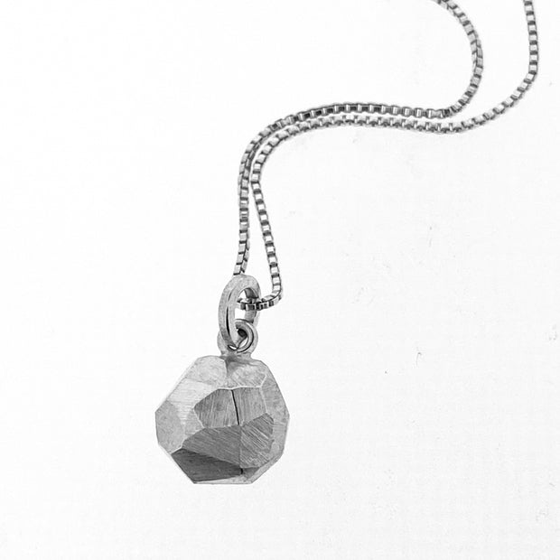 Full view of octagon pendant on silver chain.