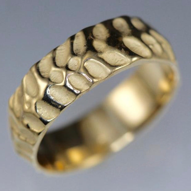Full image of Men's Cobblestone Ring in yellow gold. This wedding band's texture resembles that of a cobblestone path with the indentations left unpolished.