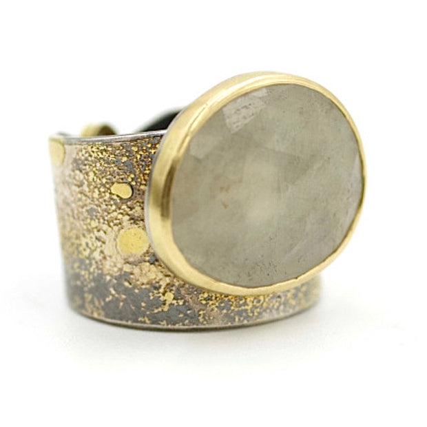 Side view of Lichen Crevice Ring - White Rose Cut Sapphire. This ring has a bezel set white sapphire on a thick oxidized silver band with gold accents.