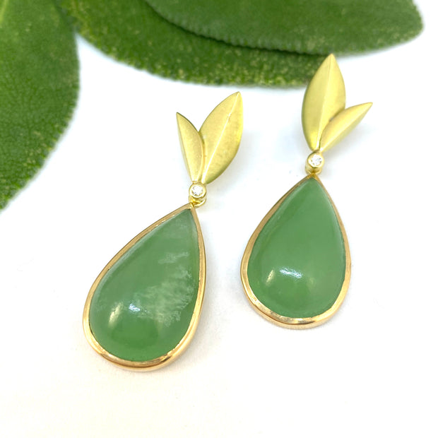 Full image of Chrysoprase - Convertible Bloom Earrings. The chrysoprase is in the shape of a teardrop encompassed in gold. At the tip of the teardrop is a set diamond and two casted gold leaves. These earrings can be worn with the teardrop chrysoprase or without.