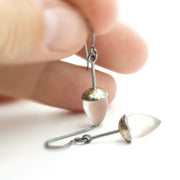 Full view of Honed Quartz Drop Earrings being held to help give an idea of its scale.