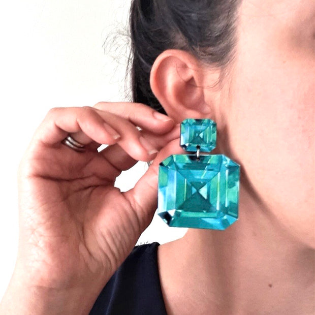 full view of Emerald Illustration - Large Drop Earrings being modeled to help give an idea of their scale.  