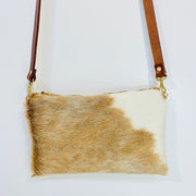 Full image of Wylie cross body bag in a blonde cowhide with brown leather strap.
