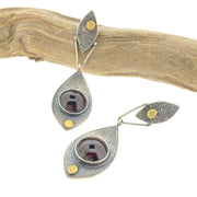 Full view of one laying up and the other on the side of Fused Botanical Dot -Garnet Earrings.