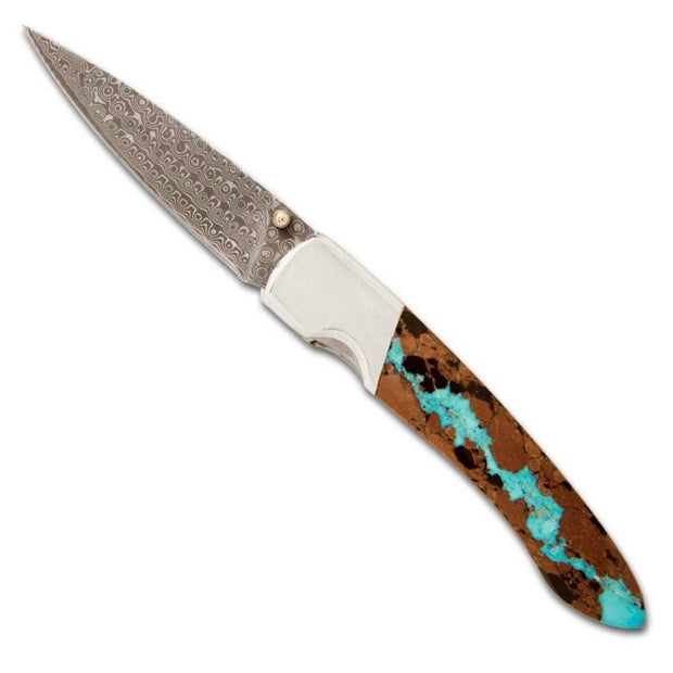 Full view of Damascus Collection Vein Turquoise 4" Liner Lock Knife with Clip. Damascus collection vein turquoise 4" liner lock knife with clip crafted by Santa Fe Stoneworks in New Mexico. There is a core of VG-10 steel with 16 layers of stainless steel on each side to produce a rust free damascus look blade. 