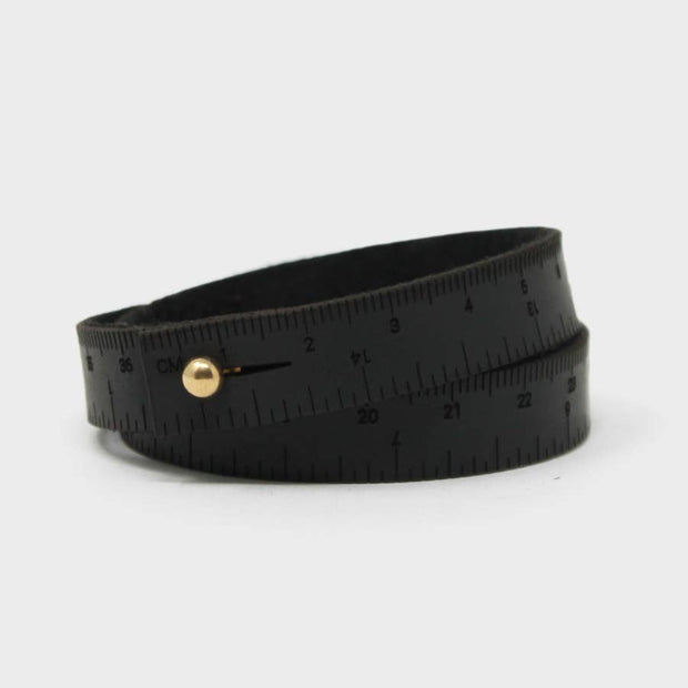 Full view of black men's Leather Wrist Ruler with brass snap closer.