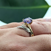 botanical leaf design nature inspired arched V shadow band wedding band , shown with vibrant purple sapphire engagement ring